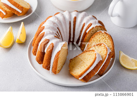 Lemon bundt cake sliced on a plate with powdered sugar glaze 113866901