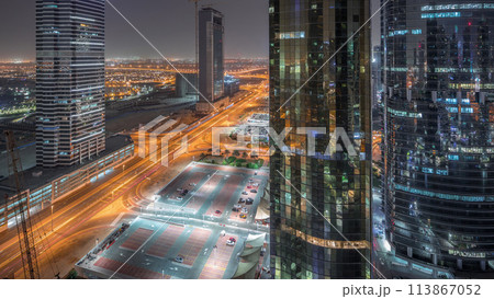 Office buildings in Jumeirah lake towers district night timelapse in Dubai 113867052