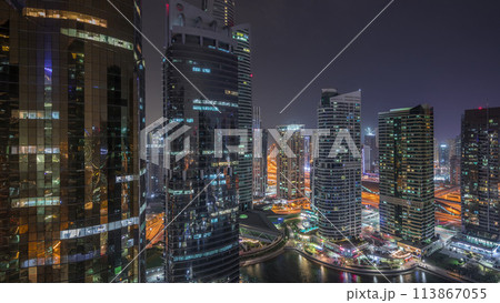 Residential and office buildings in Jumeirah lake towers district night timelapse in Dubai 113867055