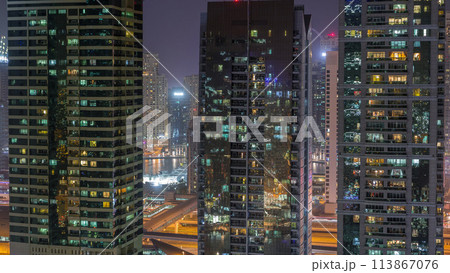 Residential and office buildings in Jumeirah lake towers district night timelapse in Dubai 113867076