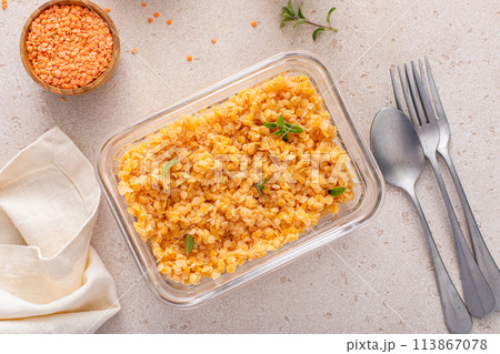 Cooked red lentils in a meal prep container, healthy vegan protein source 113867078