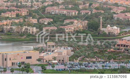 Aerial view of apartment houses and villas in Dubai city timelapse, United Arab Emirates 113867098