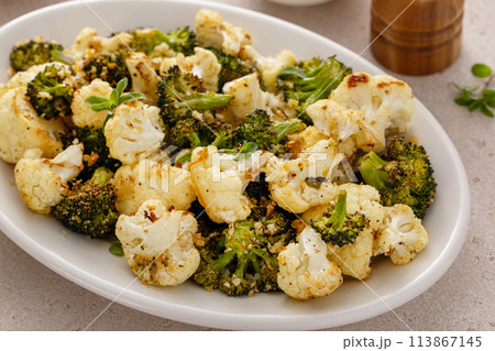 Roasted cauliflower and broccoli on a serving plate, healthy vegetable side dish 113867145