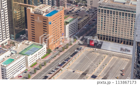 Car parking lot viewed from above timelapse, Aerial top view. Dubai, UAE Car parking lot viewed from above timelapse, Aerial top view. Dubai, UAE 113867173