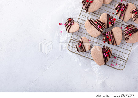 Heart shaped cookies with strawberry flavor, drizzled with dark chocolate Heart shaped cookies with strawberry flavor, drizzled with dark chocolate 113867277