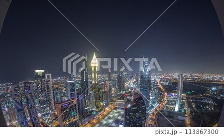 Skyline of the buildings of Sheikh Zayed Road and DIFC aerial night timelapse in Dubai, UAE. 113867300