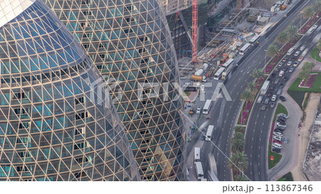 Skyline view of intersection traffic on Al Saada street near DIFC timelapse in Dubai, UAE. Skyline view of intersection traffic on Al Saada street near DIFC timelapse in Dubai, UAE. 113867346