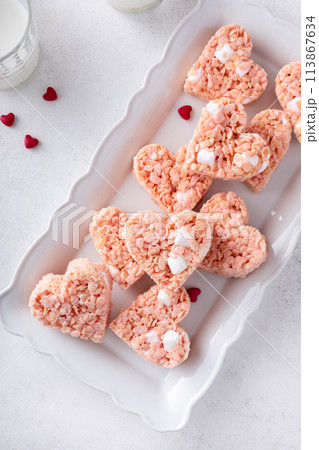 Pink heart shaped rice krispie treats served with milk 113867634