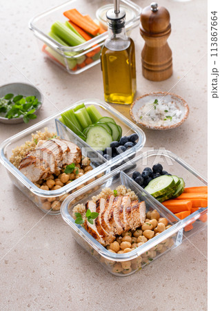 High protein healthy lunch meal prep in containers with chicken, quinoa, herbed chickpeas, vegetables and eggs High protein healthy lunch meal prep in containers with chicken, quinoa, herbed chickpeas, vegetables and eggs 113867664
