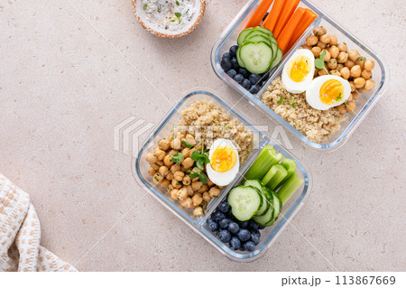 Vegetarian lunch meal prep containers high protein with quinoa, herbed chickpeas, vegetables and eggs 113867669