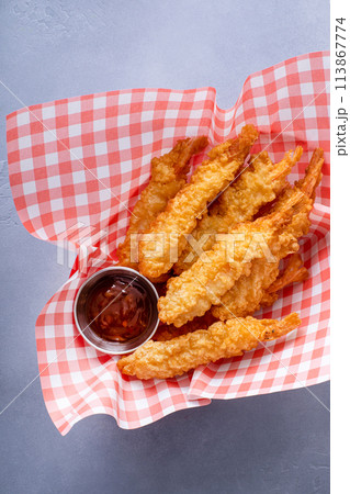 Cooked tempura shrimp in a basket with dipping sauce Cooked tempura shrimp in a basket with dipping sauce 113867774