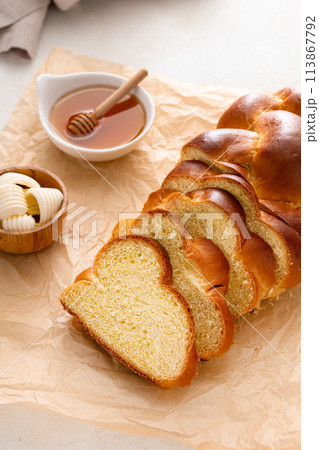 Homemade challah with honey sliced on the table 113867792