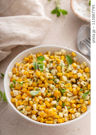 Cooked corn sauteed with butter and fresh herbs 113867795