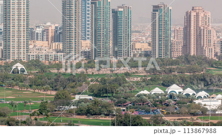 Dubai Golf Course with a cityscape of Greens and tecom districts at the background aerial timelapse Dubai Golf Course with a cityscape of Greens and tecom districts at the background aerial timelapse 113867988