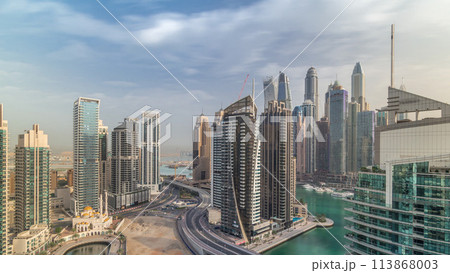Aerial view of Dubai Marina residential and office skyscrapers with waterfront timelapse Aerial view of Dubai Marina residential and office skyscrapers with waterfront timelapse 113868003