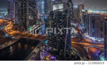 Aerial view of Dubai Marina residential and office skyscrapers with waterfront night timelapse 113868014