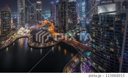 Aerial view of Dubai Marina residential and office skyscrapers with waterfront night timelapse 113868015