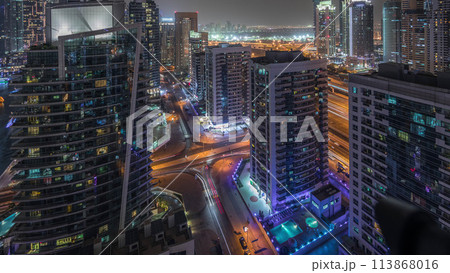 View of various skyscrapers and towers in Dubai Marina from above aerial night timelapse 113868016