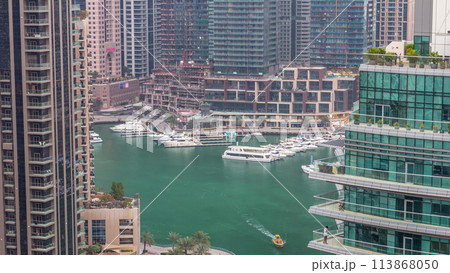 Aerial view of Dubai Marina residential and office skyscrapers with waterfront day to night timelapse Aerial view of Dubai Marina residential and office skyscrapers with waterfront day to night timelapse 113868050
