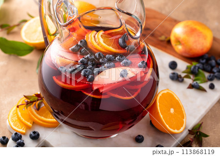 Winter orange and berry sangria with sliced oranges and blueberries Winter orange and berry sangria with sliced oranges and blueberries 113868119