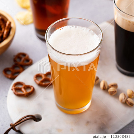 Variety of beer with snacks on the table 113868482