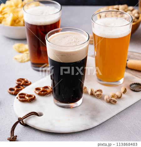 Variety of beer with snacks on the table Variety of beer with snacks on the table 113868483