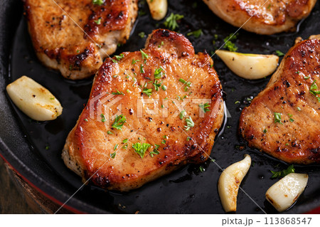 Pork chops cooked in a cast iron pan 113868547