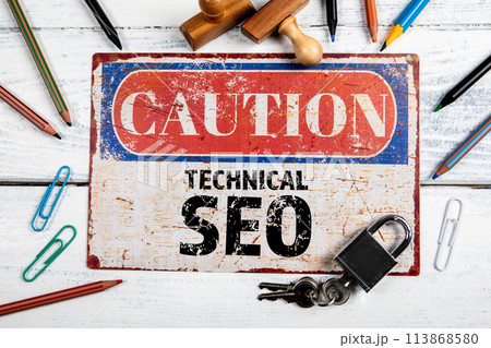 Technical SEO. Metal CAOTION plate with text on a white wooden background Technical SEO. Metal CAOTION plate with text on a white wooden background 113868580