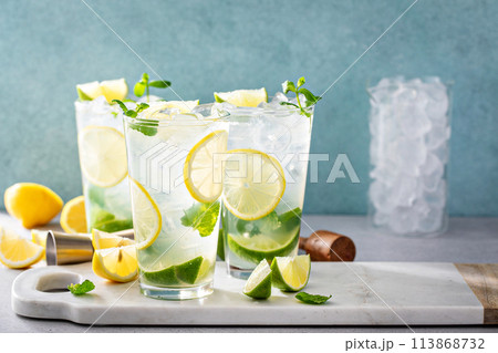 Lemon and lime mojito cocktail in tall glasses with lime and mint 113868732