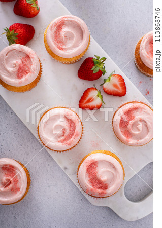 Strawberry lemonade cupcakes with a swirl of cream cheese frosting 113868746
