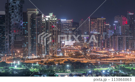 Jumeirah lake towers skyscrapers and golf course night timelapse, Dubai, United Arab Emirates 113868863