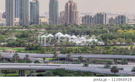 Dubai Golf Course with a cityscape of Greens and tecom districts at the background aerial timelapse 113868919