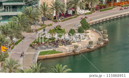 Waterfront promenade in Dubai Marina aerial timelapse. Dubai, United Arab Emirates 113868951