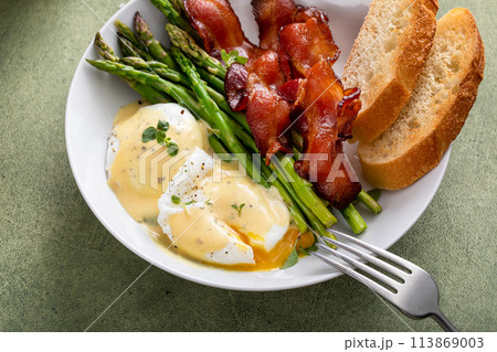 Healthy breakfast with poached eggs, bacon and asparagus Healthy breakfast with poached eggs, bacon and asparagus 113869003