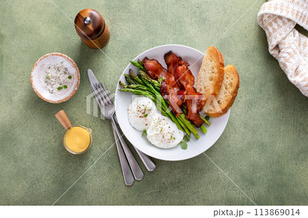 Healthy breakfast with poached eggs, bacon and asparagus Healthy breakfast with poached eggs, bacon and asparagus 113869014