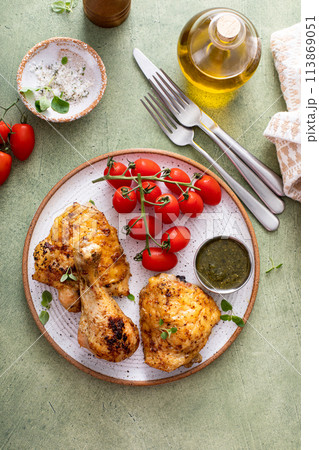Roasted lemon and herb chicken drumsticks and thighs 113869051