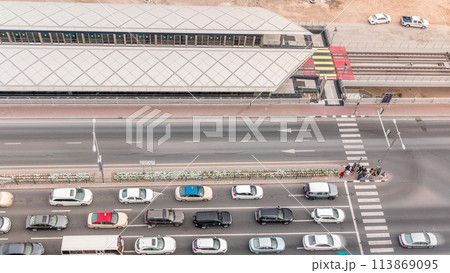 Intersection with cars and tram stop with railway aerial view from above timelapse in Dubai Marina 113869095