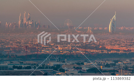 Dubai Marina and Jumeirah beach during sunrise with early morning fog timelapse in Dubai, United Arab Emirates 113869382