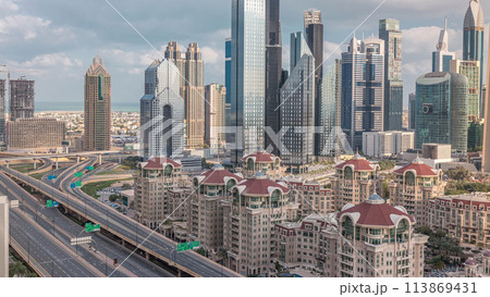 Aerial view of skyscrapers and road junction in Dubai timelapse 113869431