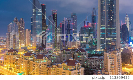 Skyline view of the buildings of Sheikh Zayed Road and DIFC night to day timelapse in Dubai, UAE. 113869433
