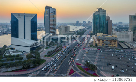 Dubai creek landscape day to night timelapse with boats and ship near waterfront 113869755