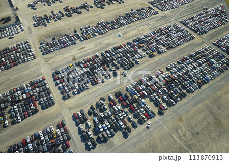 Aerial view of auction reseller company big parking lot with parked cars ready for remarketing services. Sales of secondhand vehicles Aerial view of auction reseller company big parking lot with parked cars ready for remarketing services. Sales of secondhand vehicles 113870913