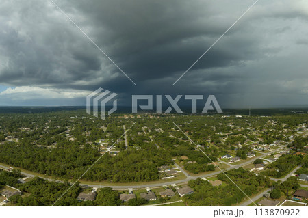 Landscape of dark ominous clouds forming on stormy sky before heavy thunderstorm over rural town area 113870922