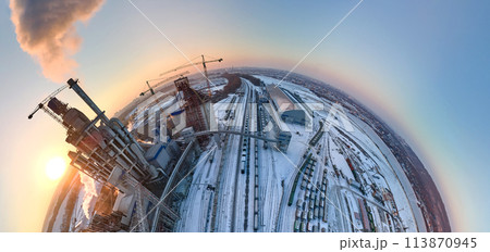 Aerial view from high altitude of little planet earth with cement factory high concrete structure and tower crane at industrial production area in evening. Manufacture and global industry concept Aerial view from high altitude of little planet earth with cement factory high concrete structure and tower crane at industrial production area in evening. Manufacture and global industry concept 113870945