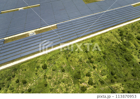 Aerial view of big sustainable electric power plant with many rows of solar photovoltaic panels for producing clean electrical energy. Renewable electricity with zero emission concept 113870953