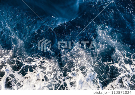 Top down aerial view of sea water surface. White foam waves texture as natural background. Top down aerial view of sea water surface. White foam waves texture as natural background. 113871024