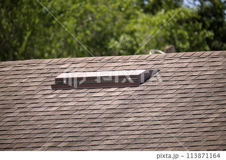 Closeup of house roof top covered with asphalt or bitumen shingles. Waterproofing of new building 113871164