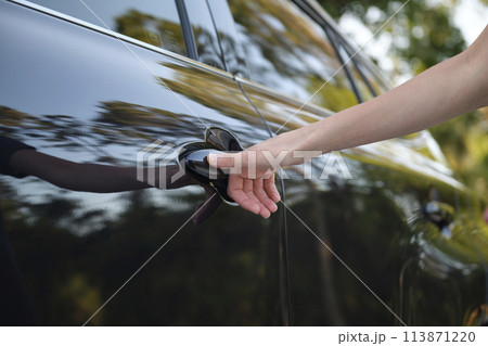 Closeup of driver hand opening car front door with touch ID finger imprint scanning technology. Vehicle safety concept 113871220