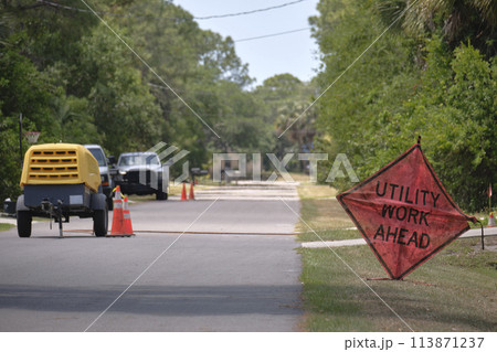 Road work ahead sign on street site as warning to cars about construction and utility works Road work ahead sign on street site as warning to cars about construction and utility works 113871237