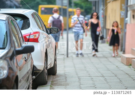 Close up of a car parked illegally against traffic rules on pedestrian city street side Close up of a car parked illegally against traffic rules on pedestrian city street side 113871265